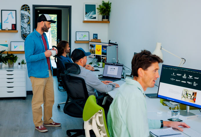 The Oracle Design Studio with people working at there desks and a dog